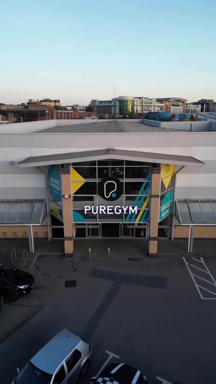 Gym floor promotional video frame showing training equipment inside a PureGym venue