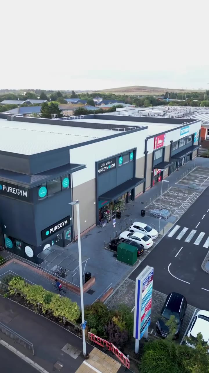 Aerial exterior drone shot of a PureGym venue and its surroundings